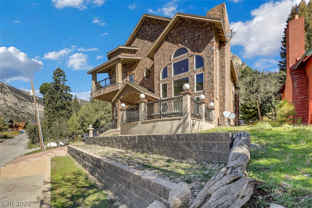264 Crestview Drive Mount Charleston, NV 89124 - Photo 5 of 78 This majestic stone home features intricate architectural details, commanding attention amidst its natural surroundings.