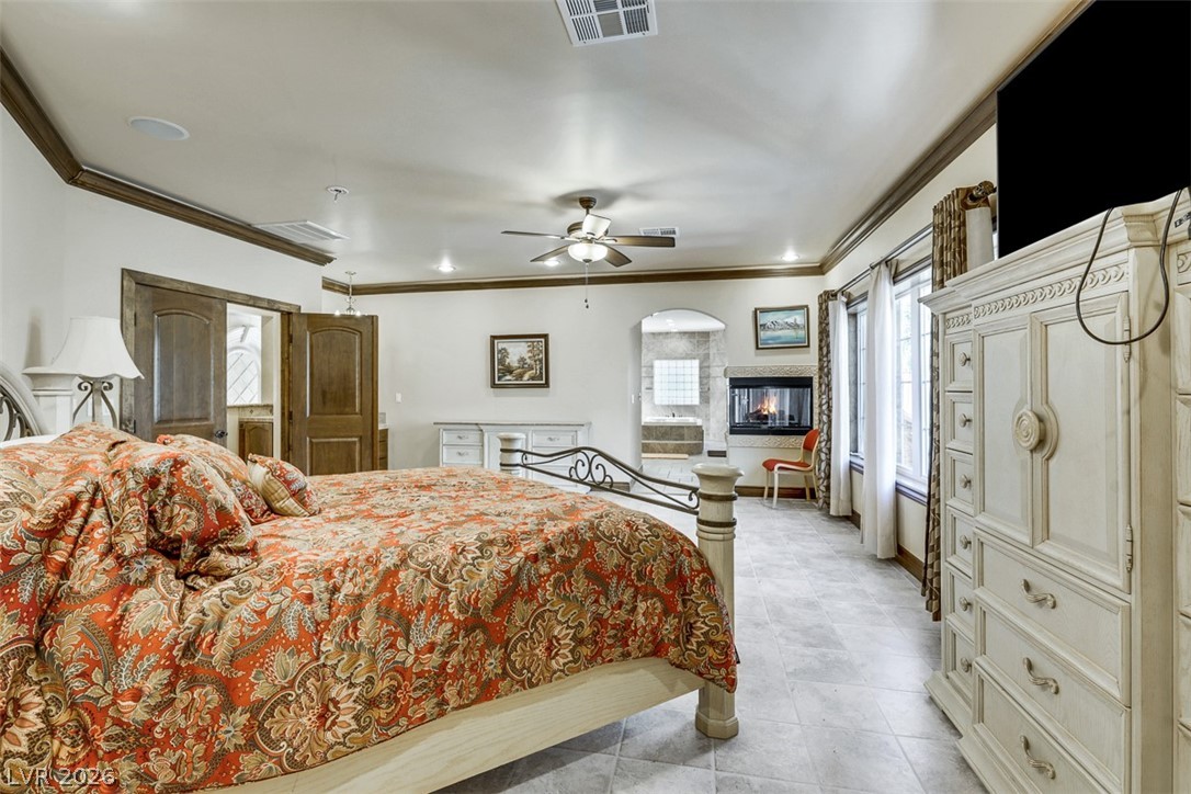 264 Crestview Drive Mount Charleston, NV 89124 - Photo 54 of 78 This spacious primary bedroom features a cozy fireplace and convenient access to a luxurious en-suite bathroom.
