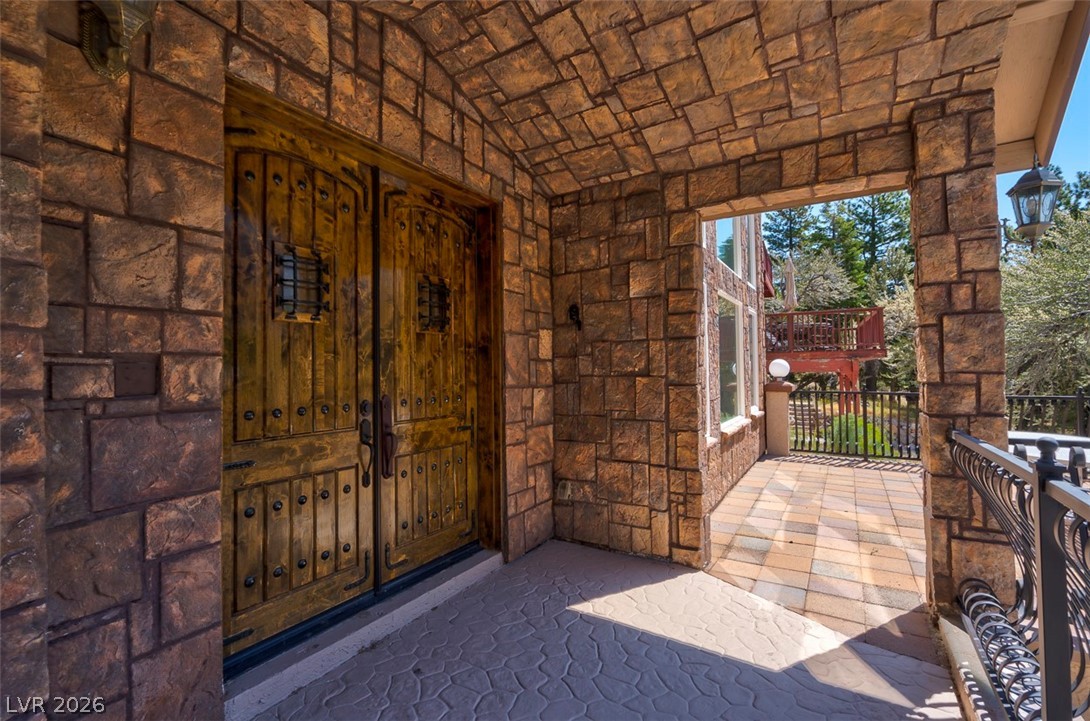 264 Crestview Drive Mount Charleston, NV 89124 - Photo 6 of 78 Enter through rustic doors into a stone archway leading to a private deck.