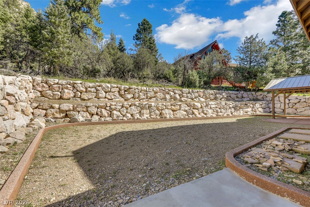 264 Crestview Drive Mount Charleston, NV 89124 - Photo 70 of 78 This yard features a stone retaining wall and an inviting gazebo perfect for outdoor enjoyment.