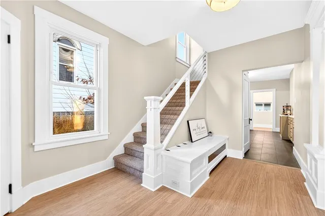 a view of a livingroom with wooden floor and stairs