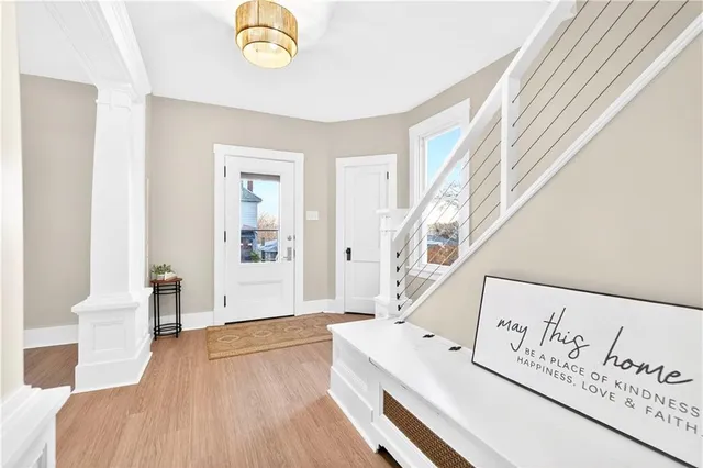 a view of an entryway with wooden floor