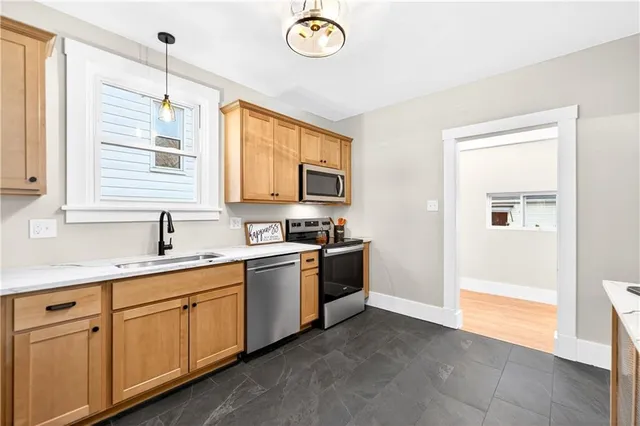 a kitchen with a sink stove and microwave