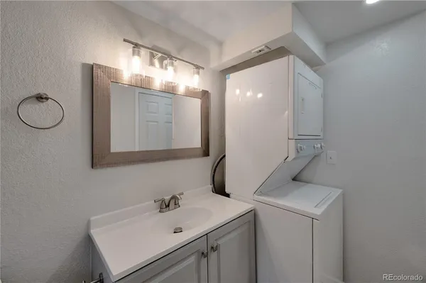 a bathroom with a sink vanity and mirror