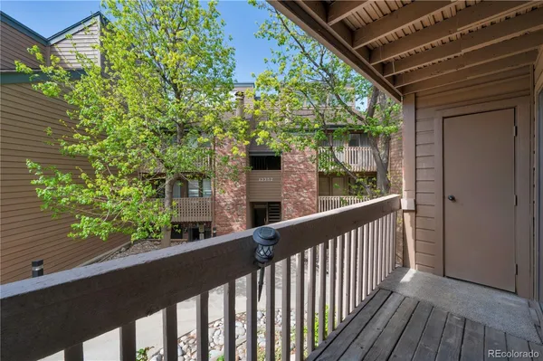 a view of a balcony with wooden floor