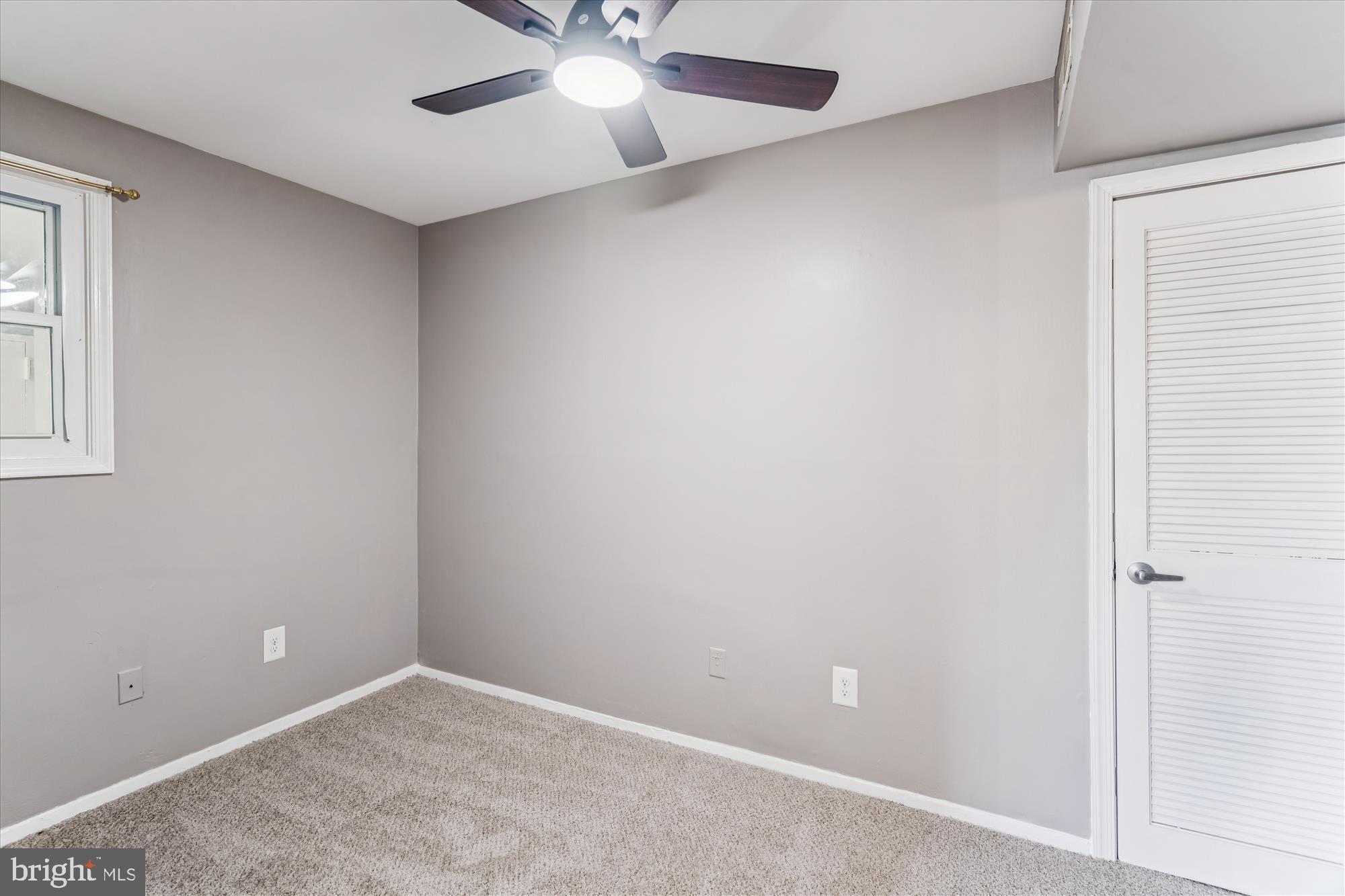 7973 Riggs Road, Unit 8 Hyattsville, MD 20783 - Photo 15 of 45 an empty room with a window and a fan