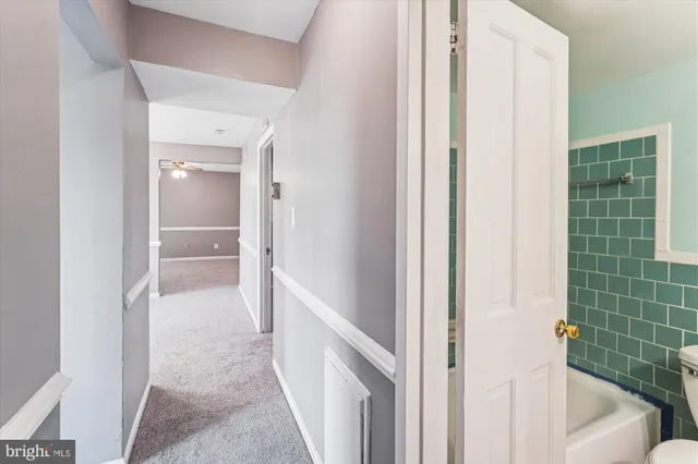 a view of a bathroom from a corridor