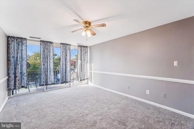 a view of a livingroom with a ceiling fan and window