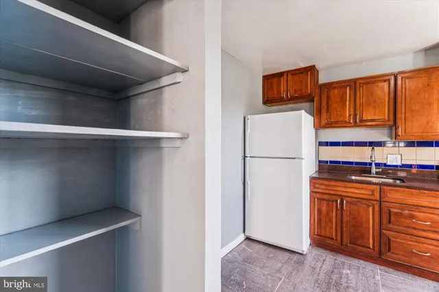 a kitchen with stainless steel appliances a refrigerator and a stove top oven
