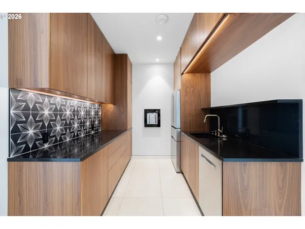 a hallway with a large kitchen stove and a microwave oven