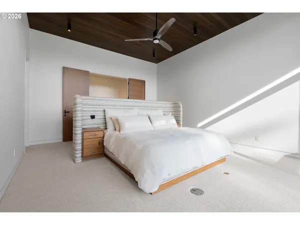 a bedroom with a bed and a television