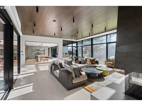 a living room with furniture large window and outer view