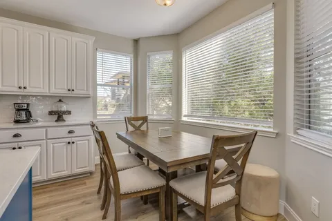 a view of a dining room with furniture and windows