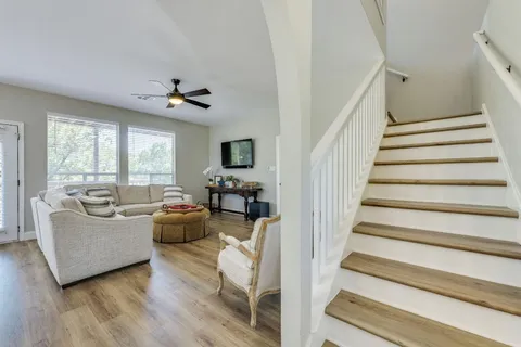 a living room with furniture and a chandelier