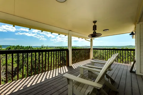 a view of a balcony with floor to ceiling windows with wooden floor