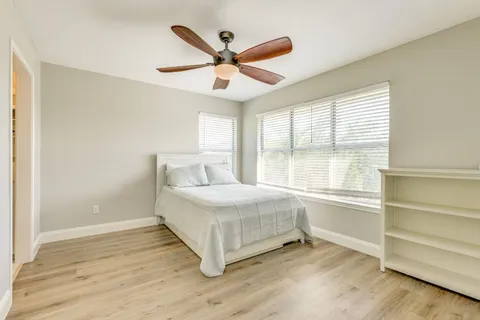 a spacious bedroom with a bed and a window