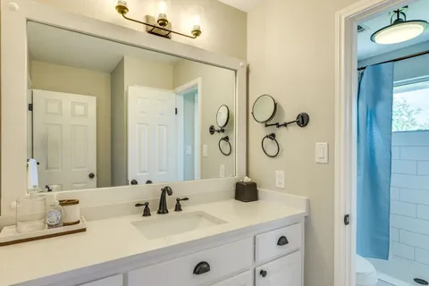a bathroom with a granite countertop sink mirror and double