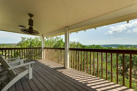 a view of balcony with wooden floor & fence