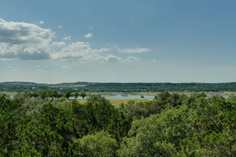 a view of a lake with houses in the back