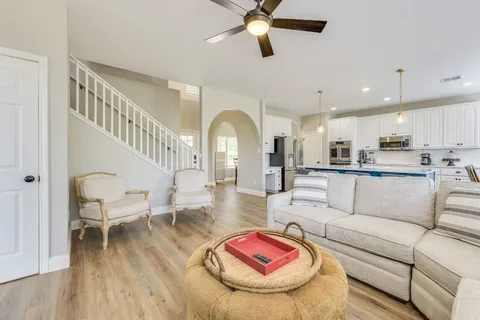a living room with furniture and kitchen view