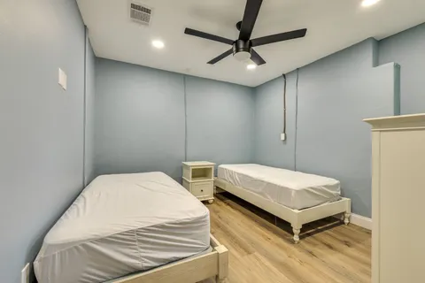 a bedroom with a bed and a chandelier