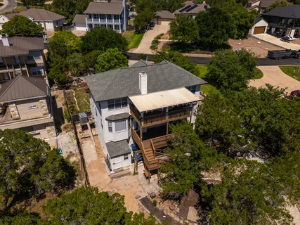 an aerial view of a house with garden space and street view