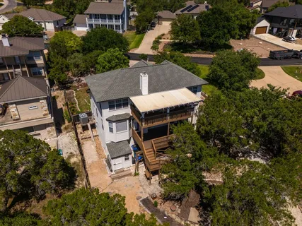 an aerial view of a house with garden space and street view