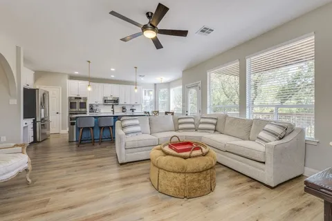 a living room with furniture and kitchen view
