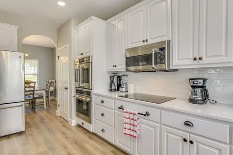 a kitchen with stainless steel appliances a stove microwave and refrigerator