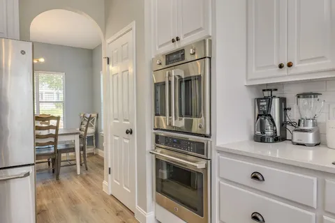 a kitchen with cabinets and stainless steel appliances