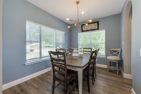 a view of a dining room with furniture window and wooden floor