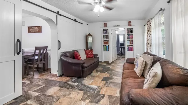 a living room with furniture ceiling fan and a rug