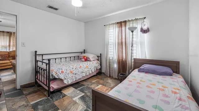 a bedroom with a bed and a window