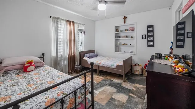 a bedroom with a bed and a window