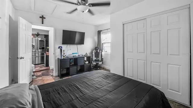 a bedroom with a bed and a flat tv screen