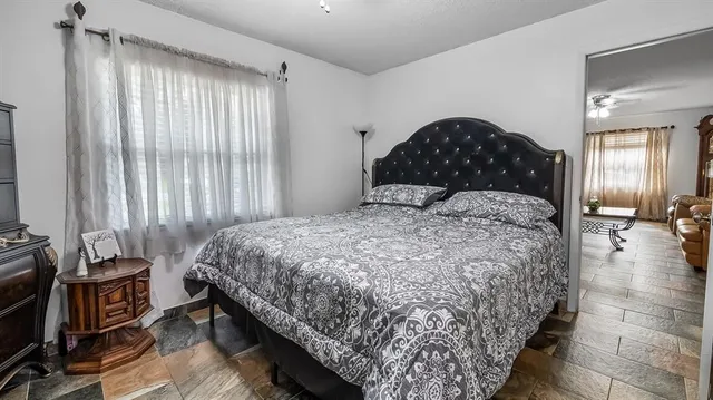 a bedroom with a bed and a window