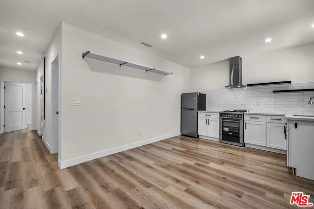 a view of a kitchen with a sink a refrigerator and window