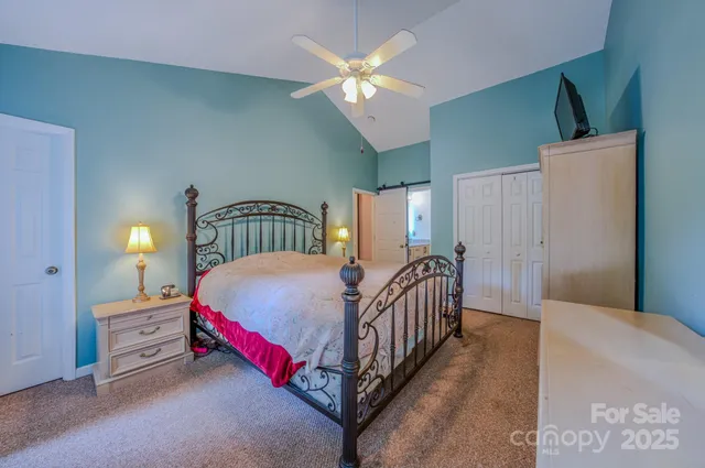 a bed sitting in a bedroom next to a window