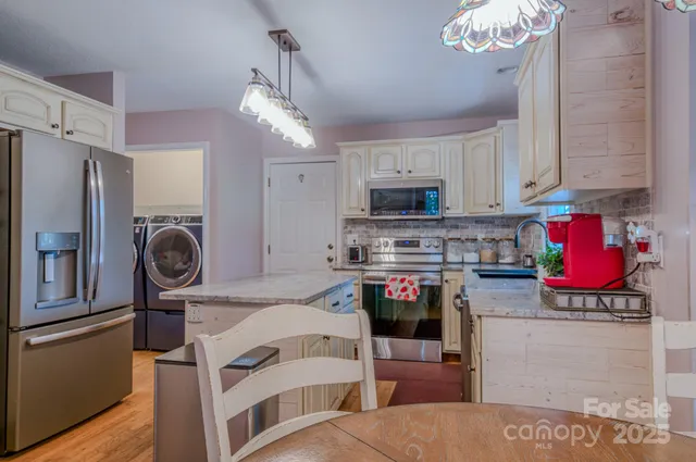a kitchen with stainless steel appliances granite countertop a stove and a refrigerator
