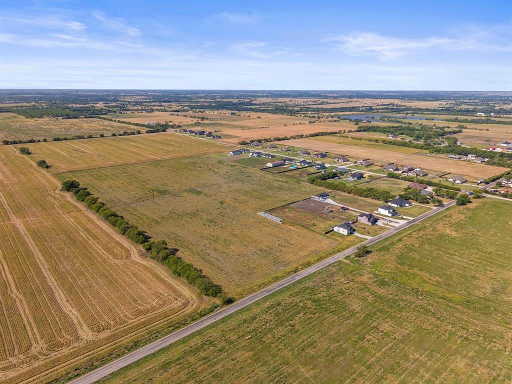 3885 Lois Road West Sanger, TX 76266 - Photo 10 of 12 Expansive open land with cultivated fields and a paved road