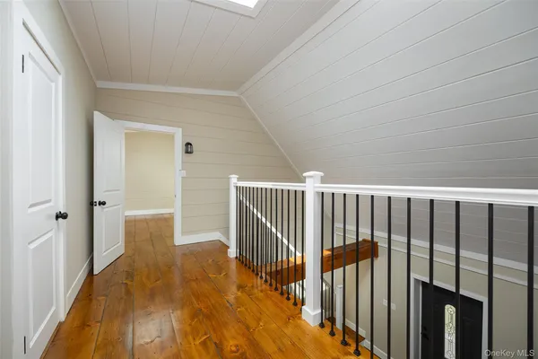 a view of a room with wooden floor and bathroom