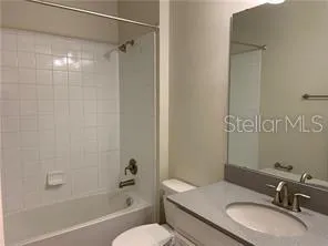 a view of an empty room with wooden floor and a large window