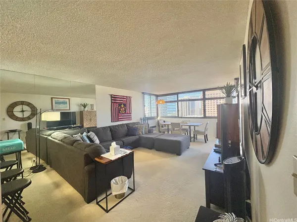 a living room with furniture a window and a fireplace
