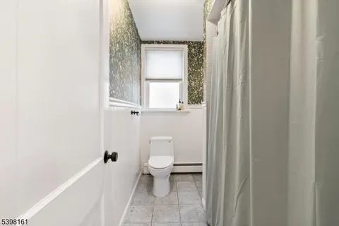a white toilet sitting next to a window