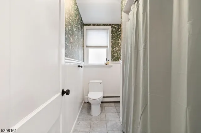 a white toilet sitting next to a window