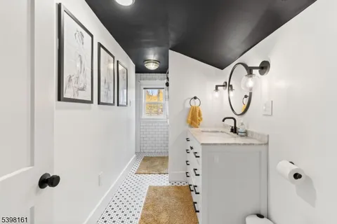 a bathroom with a sink a mirror and shower