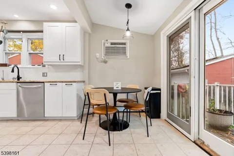 a view of kitchen with cabinets and window