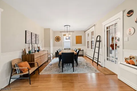 a living room with furniture dining table and wooden floor