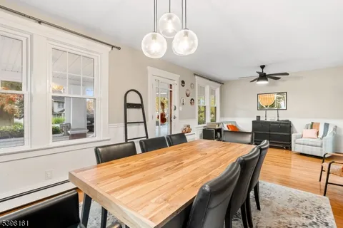 a dining room with a table chairs and a kitchen view