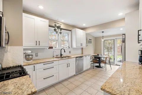 a large white kitchen with a large window